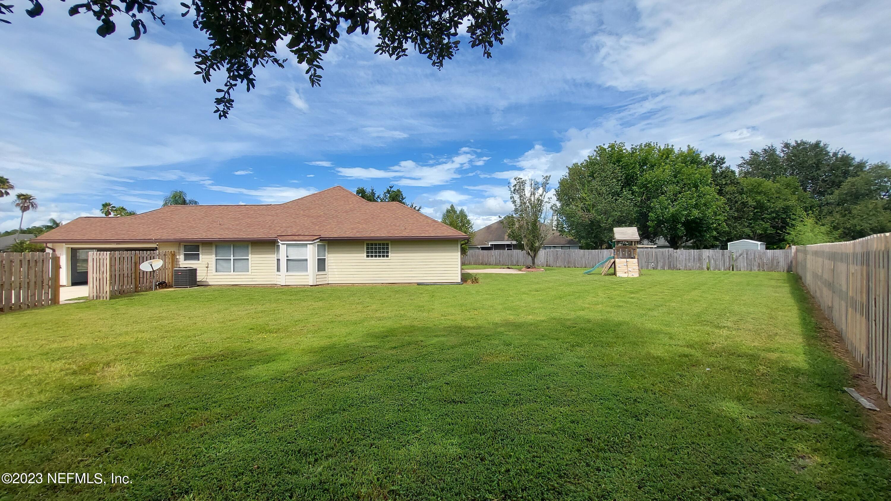 1763 Pickwick Place Orange Park, FL 32003 - Photo 22 of 24 a view of a big house with a big yard and large trees