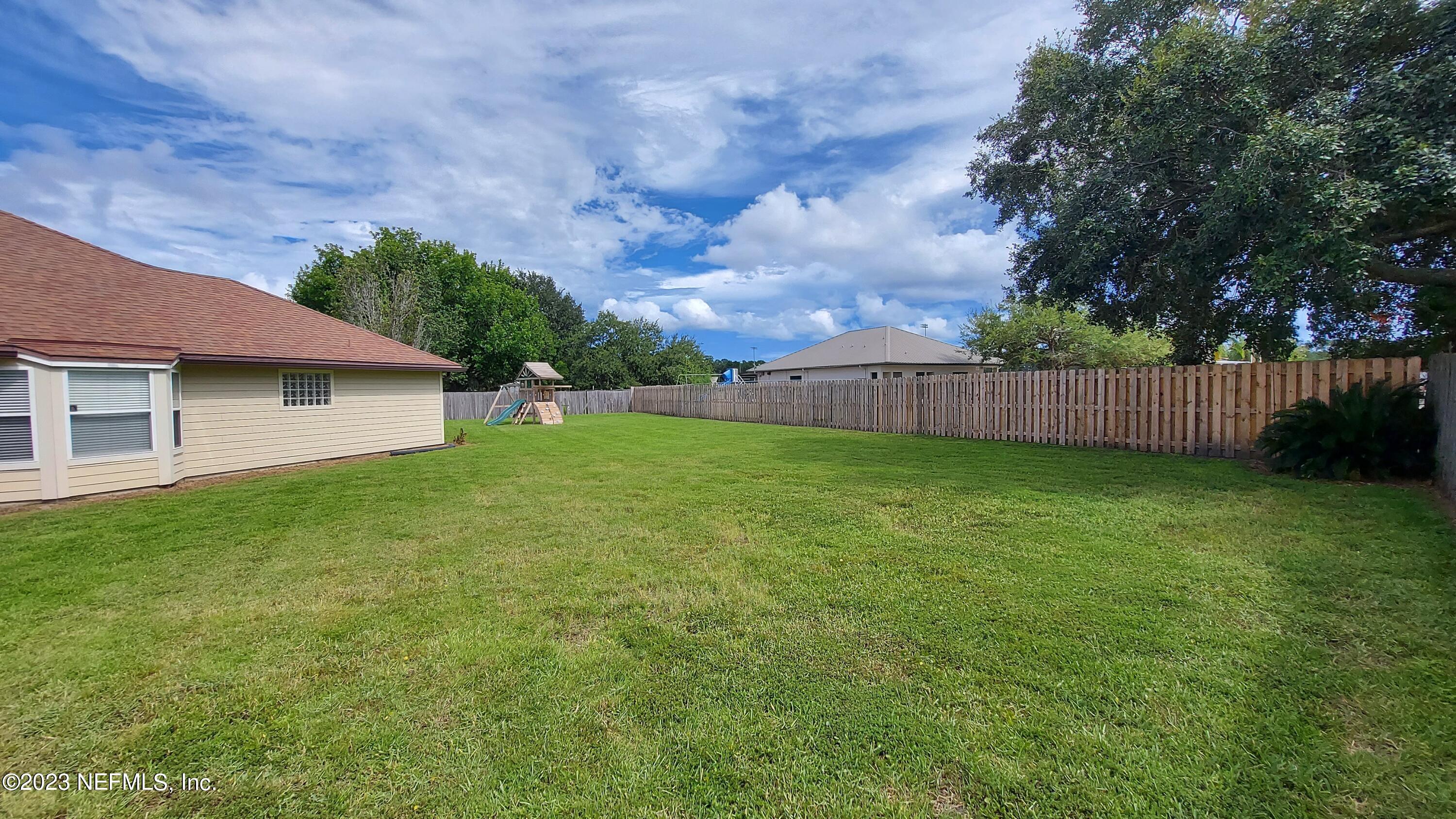 1763 Pickwick Place Orange Park, FL 32003 - Photo 23 of 24 a view of a backyard with a garden