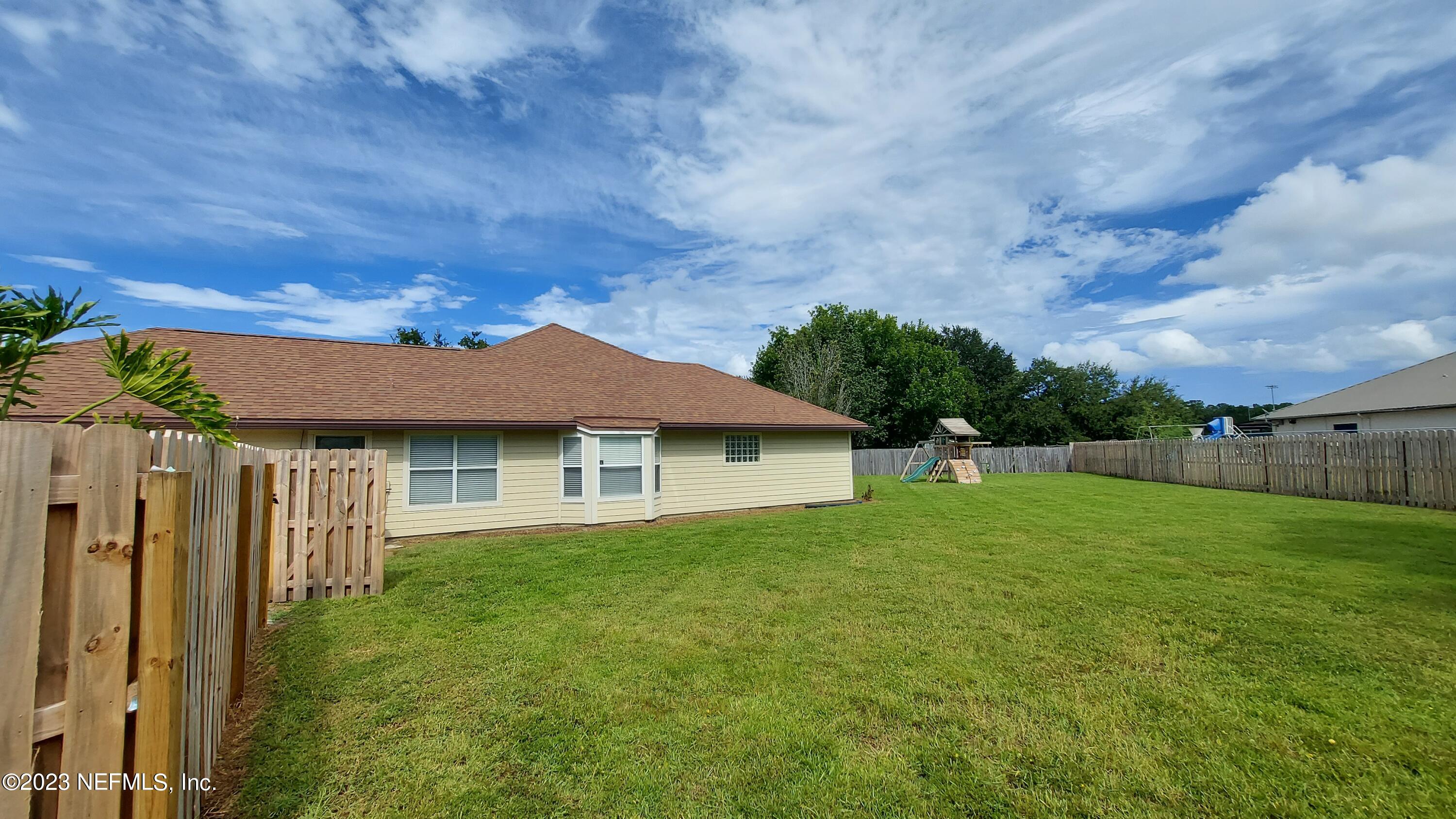 1763 Pickwick Place Orange Park, FL 32003 - Photo 24 of 24 a backyard of a house with plants and large tree
