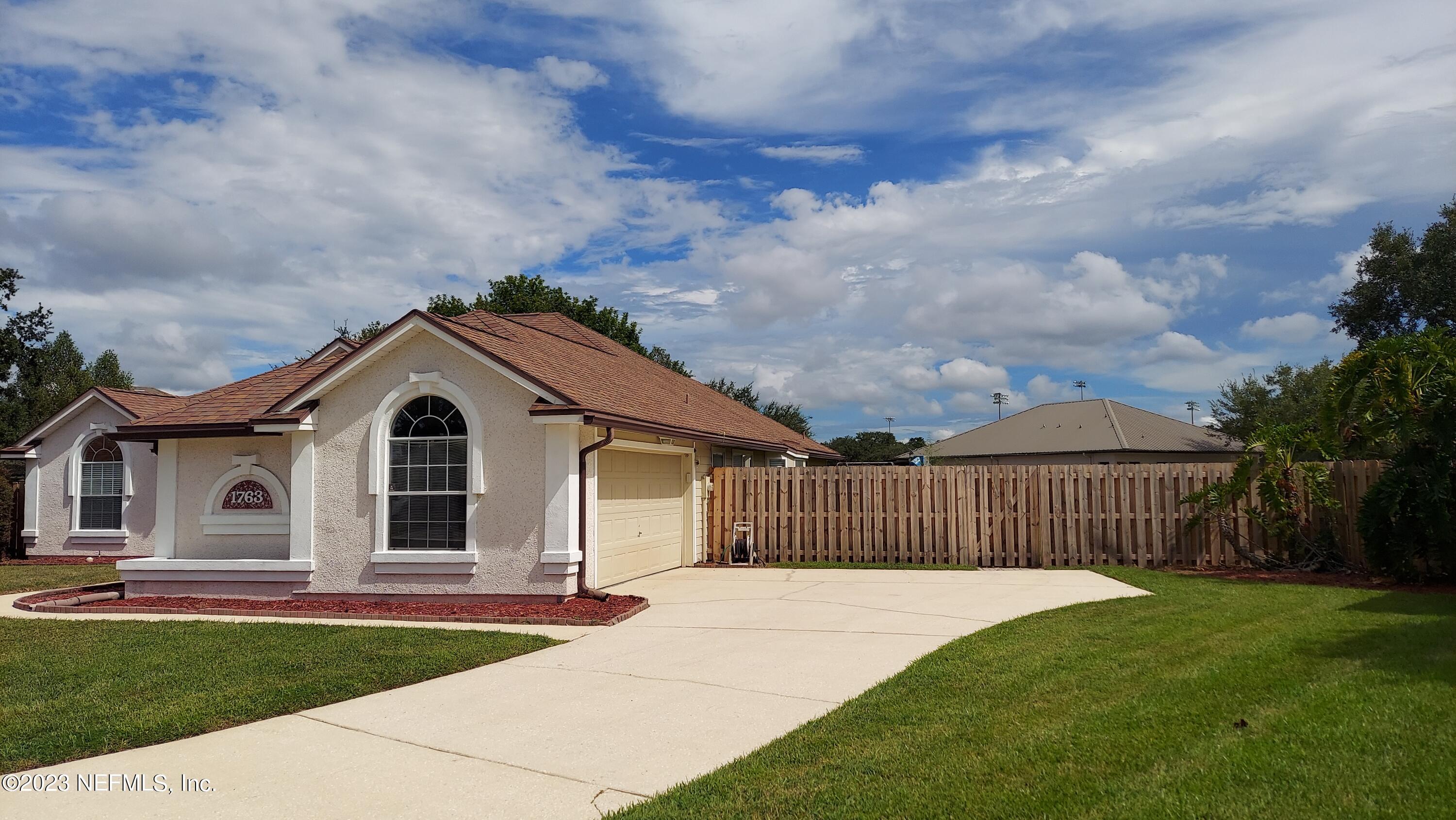 1763 Pickwick Place Orange Park, FL 32003 - Photo 3 of 24 a front view of a house with a garden