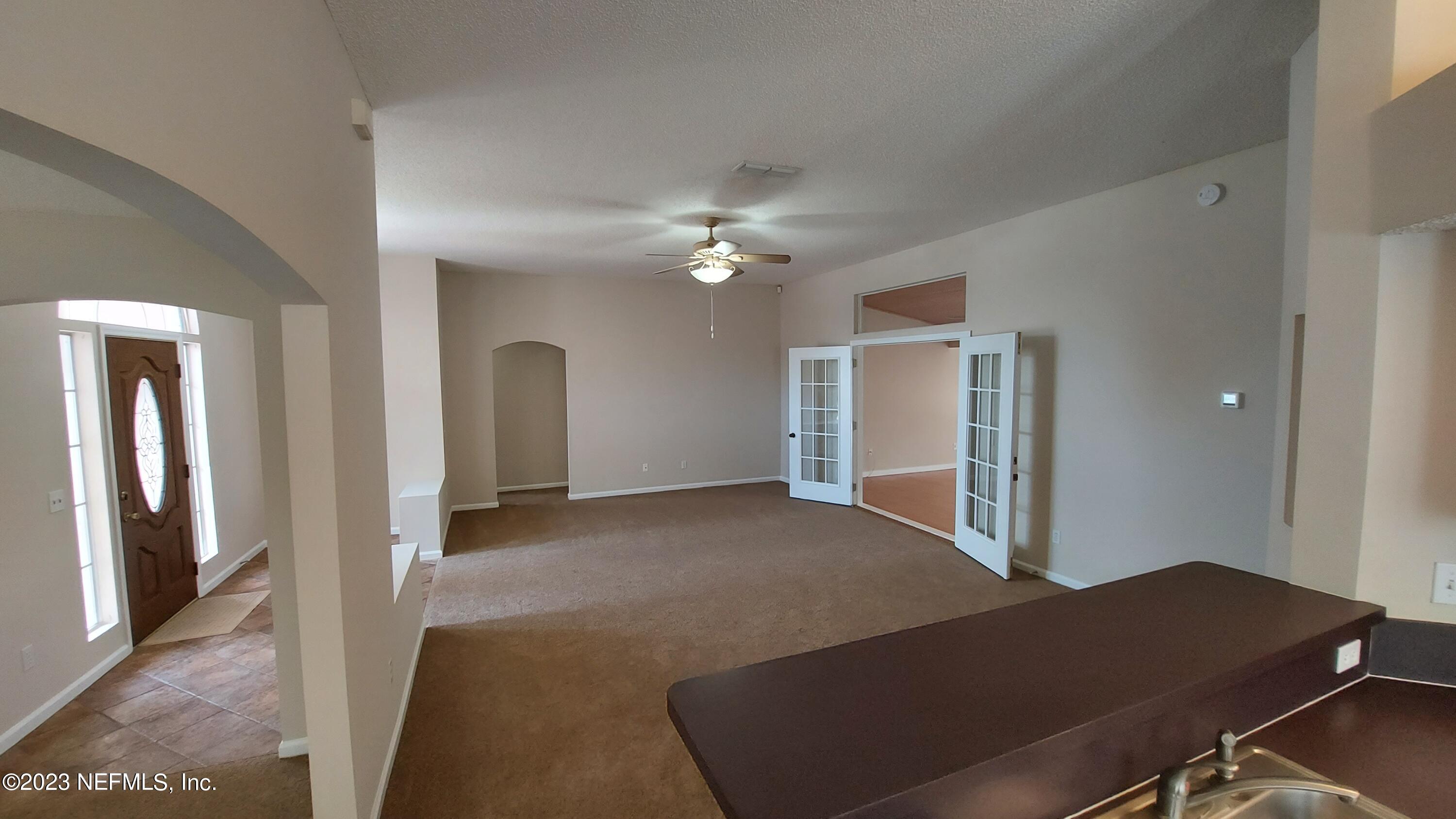 1763 Pickwick Place Orange Park, FL 32003 - Photo 6 of 24 a view of a livingroom with a ceiling fan and window