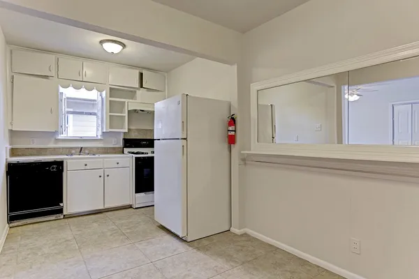 a kitchen with a refrigerator and a sink