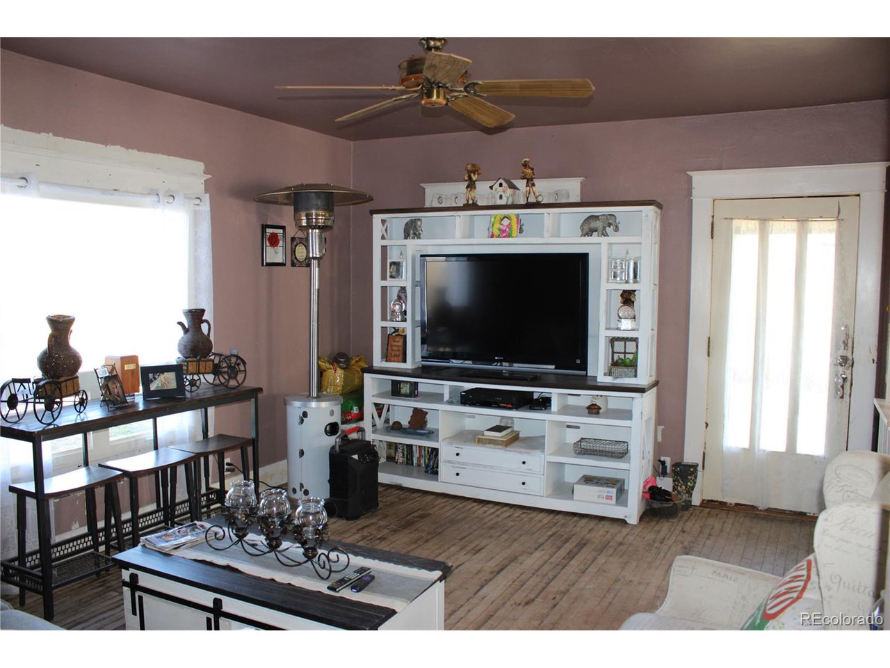 1901 County Rd H Joes, CO 80822 - Photo 29 of 42 a living room with furniture and a flat screen tv