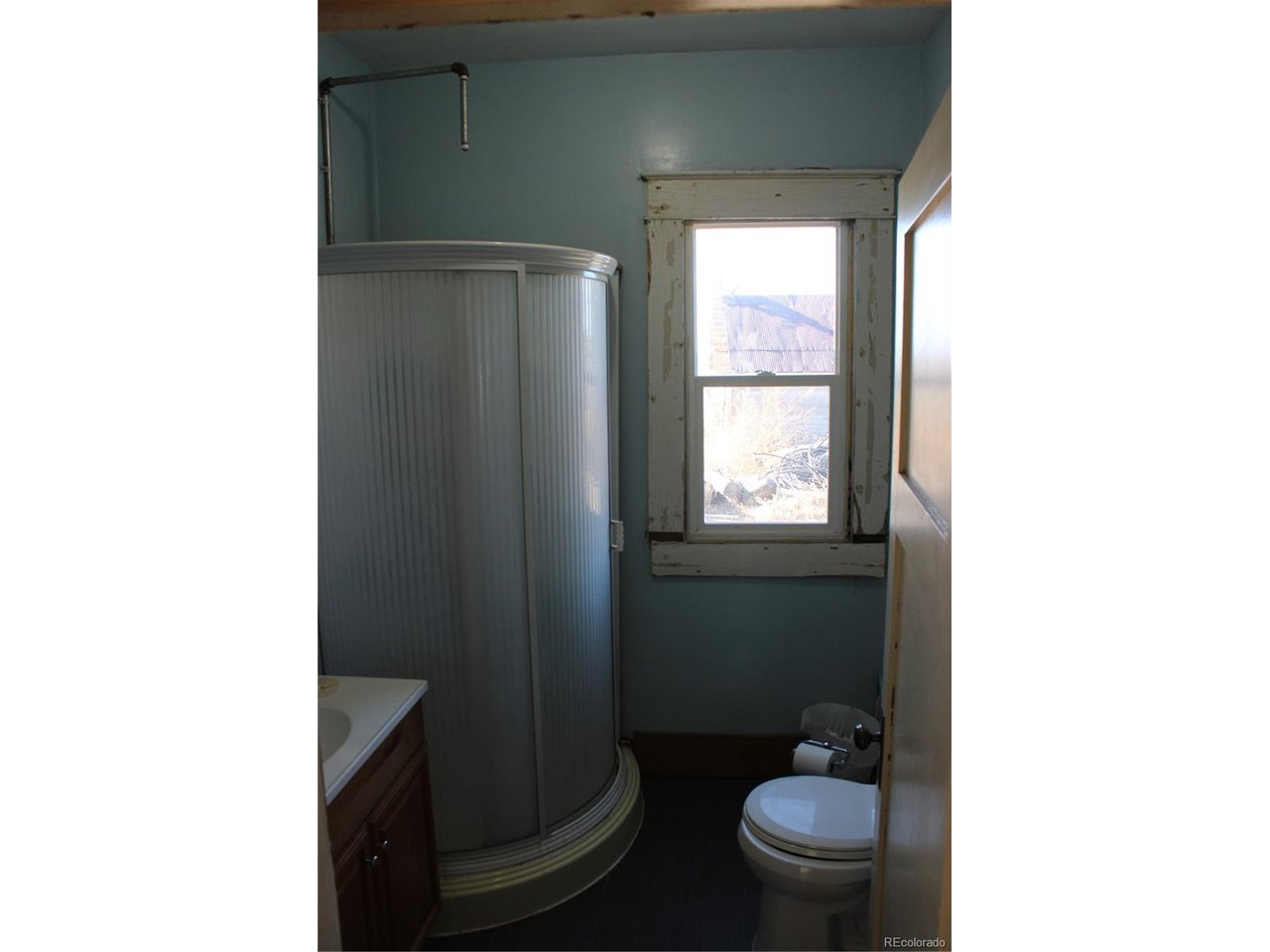 1901 County Rd H Joes, CO 80822 - Photo 30 of 42 a bathroom with a toilet and a shower curtain