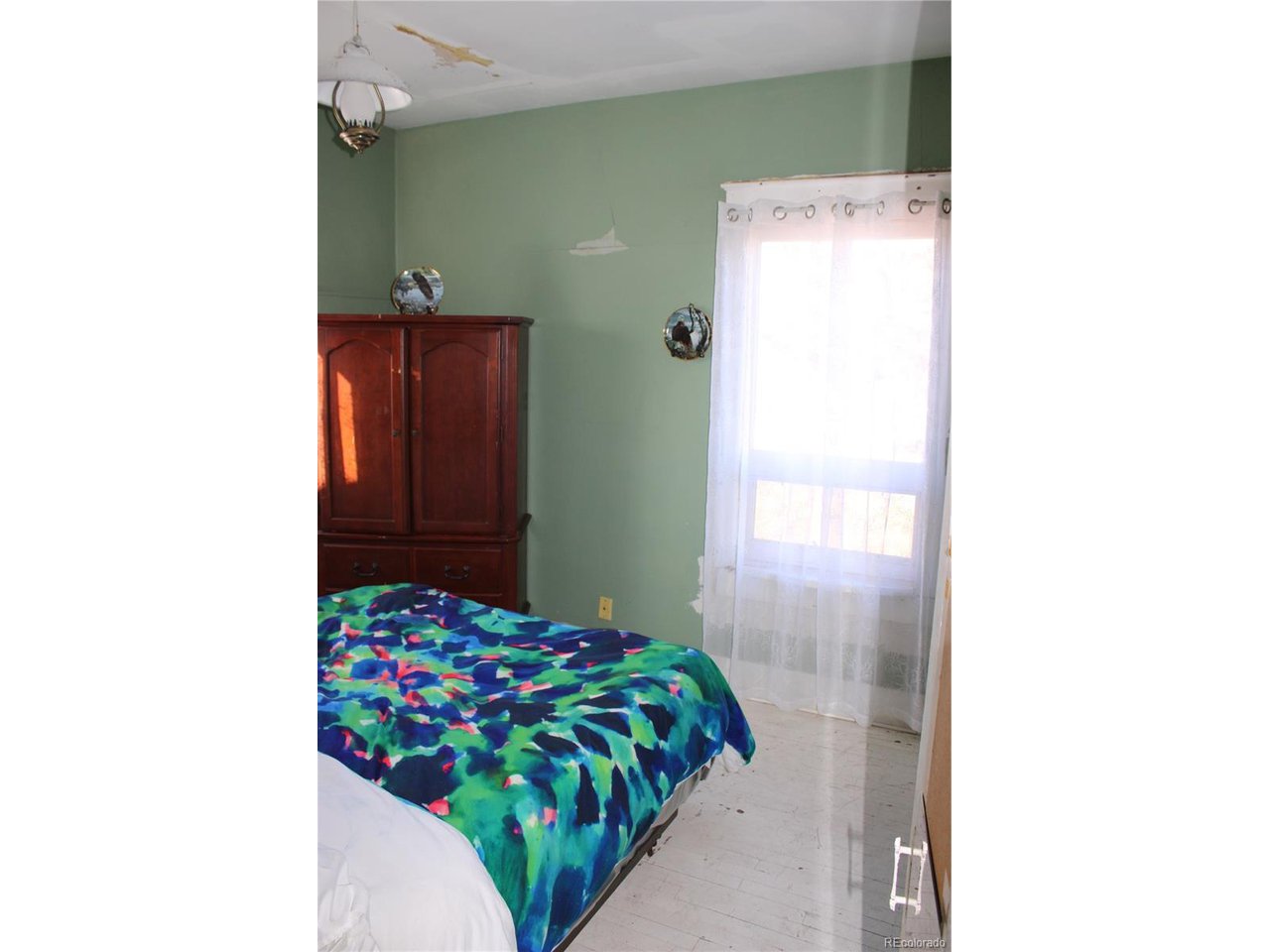 1901 County Rd H Joes, CO 80822 - Photo 34 of 42 a bedroom with a bed and a cabinets