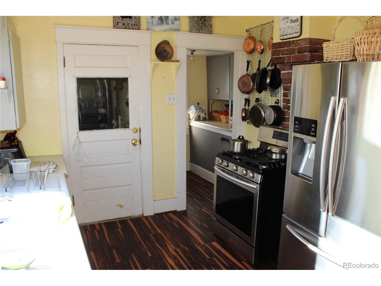 1901 County Rd H Joes, CO 80822 - Photo 36 of 42 a kitchen with a refrigerator and cabinets