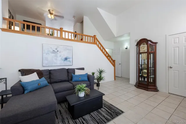 a living room with furniture and a book shelf