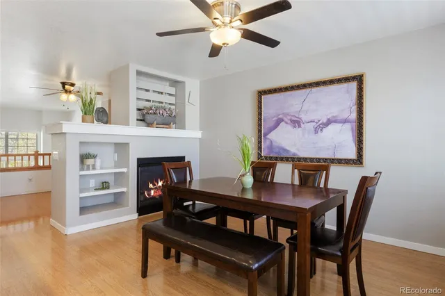 a view of a dining room with furniture and a fireplace