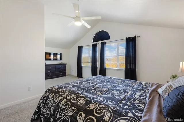 a large bedroom with a bed and a chandelier