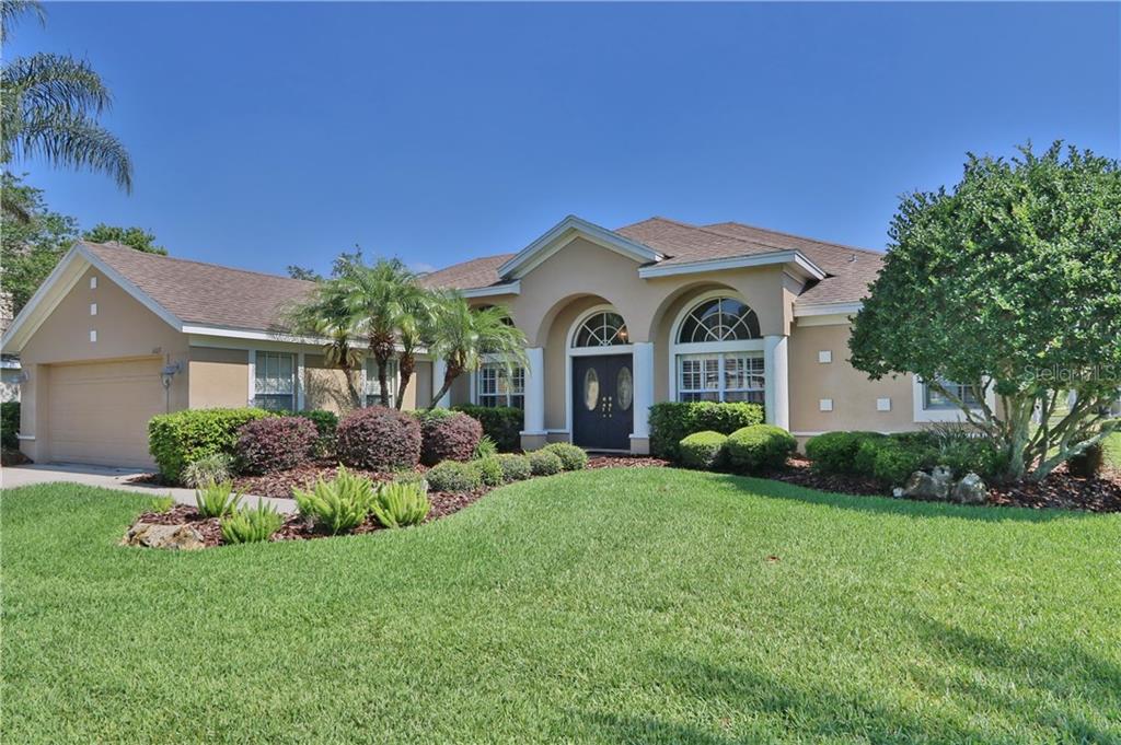6103 Chene Court Lutz, FL 33558 - Photo 1 of 1 a front view of a house with a garden