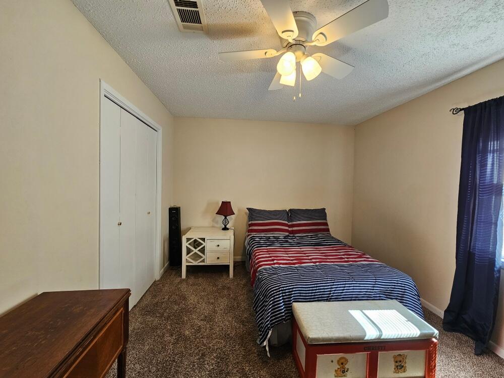 4017 Bear Creek Road Crestview, FL 32539 - Photo 14 of 30 a bedroom with a bed and a window