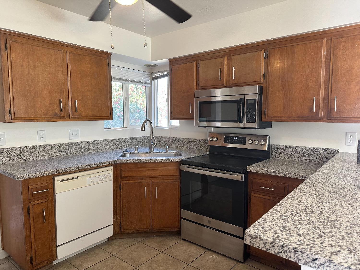 Undisclosed Address Bakersfield, CA 93306 - Photo 15 of 15 a kitchen with sink cabinets and microwave