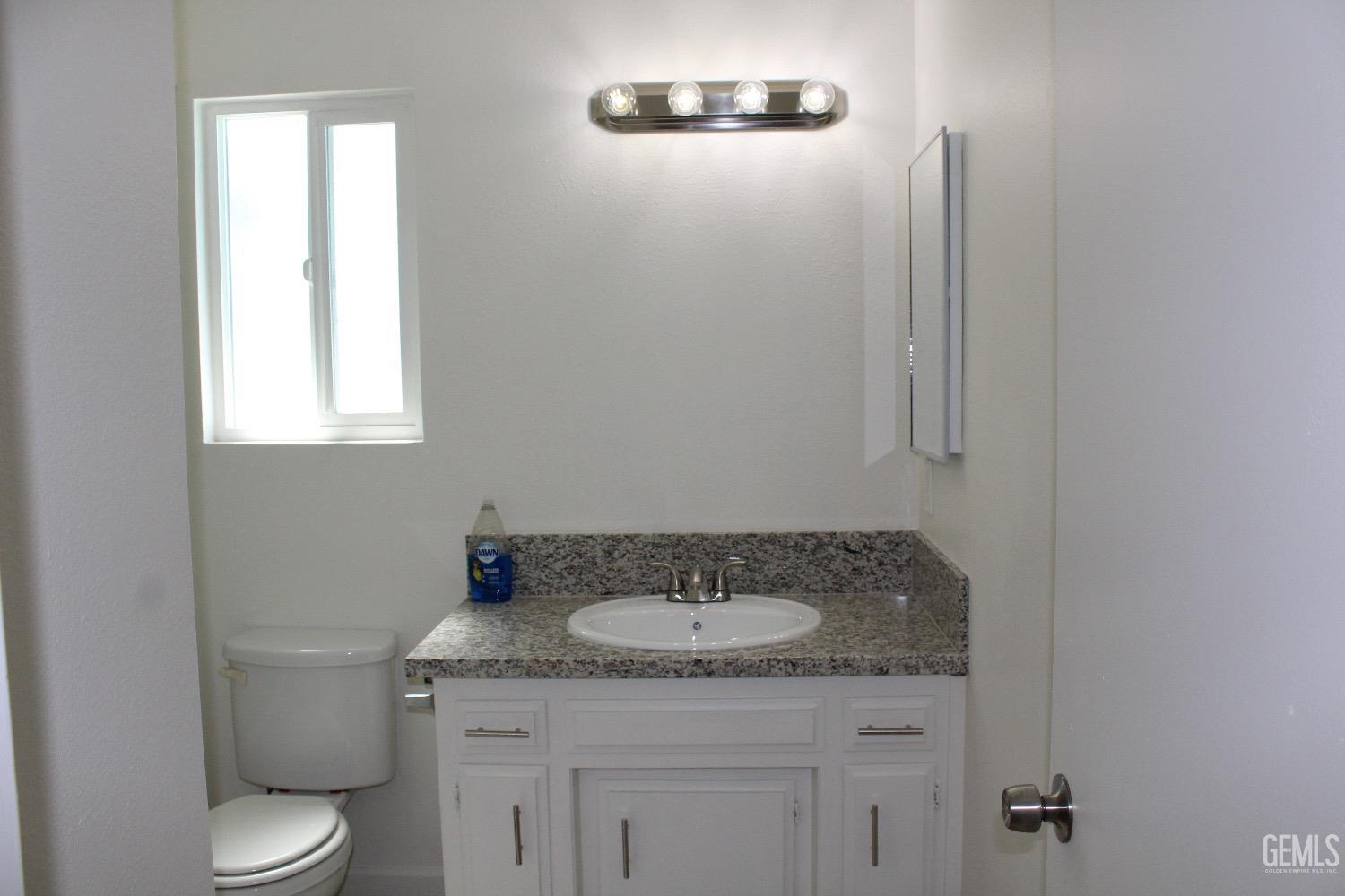 Undisclosed Address Bakersfield, CA 93306 - Photo 3 of 15 a bathroom with a granite countertop sink toilet and a mirror