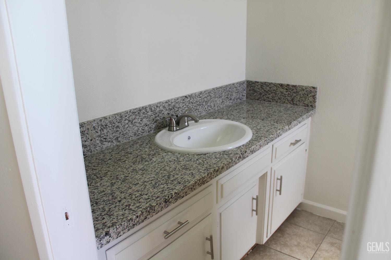 Undisclosed Address Bakersfield, CA 93306 - Photo 9 of 15 a bathroom with a granite countertop sink and a mirror