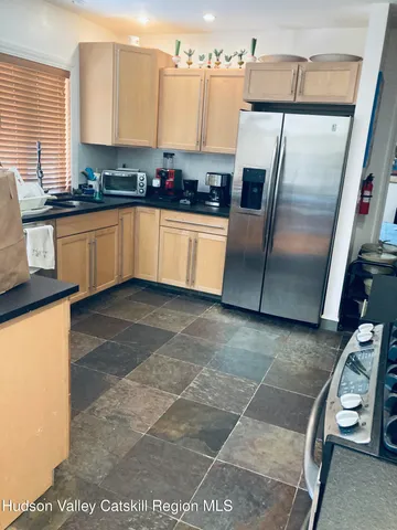 a living room with fireplace furniture and a large window