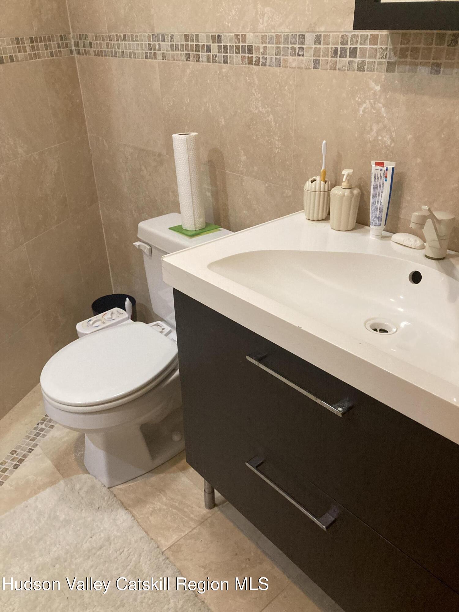 537 Mossy Hill Road Catskill, NY 12414 - Photo 25 of 38 a bathroom with a sink a toilet and mirror