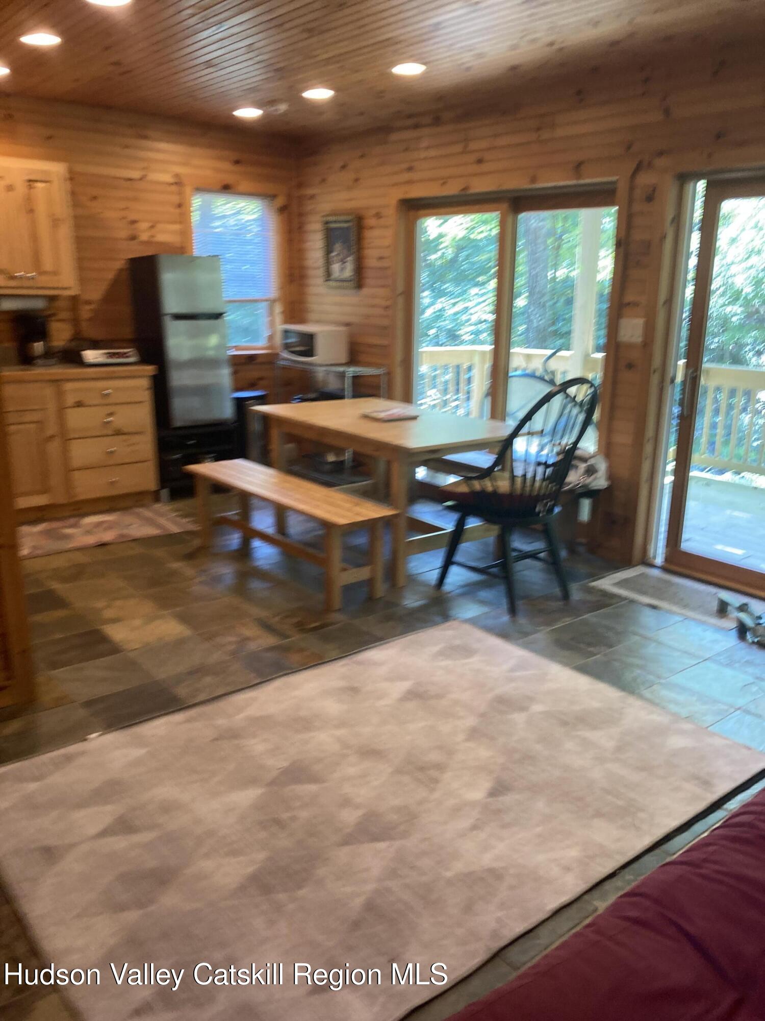 537 Mossy Hill Road Catskill, NY 12414 - Photo 29 of 38 a living room with fireplace furniture and a large window