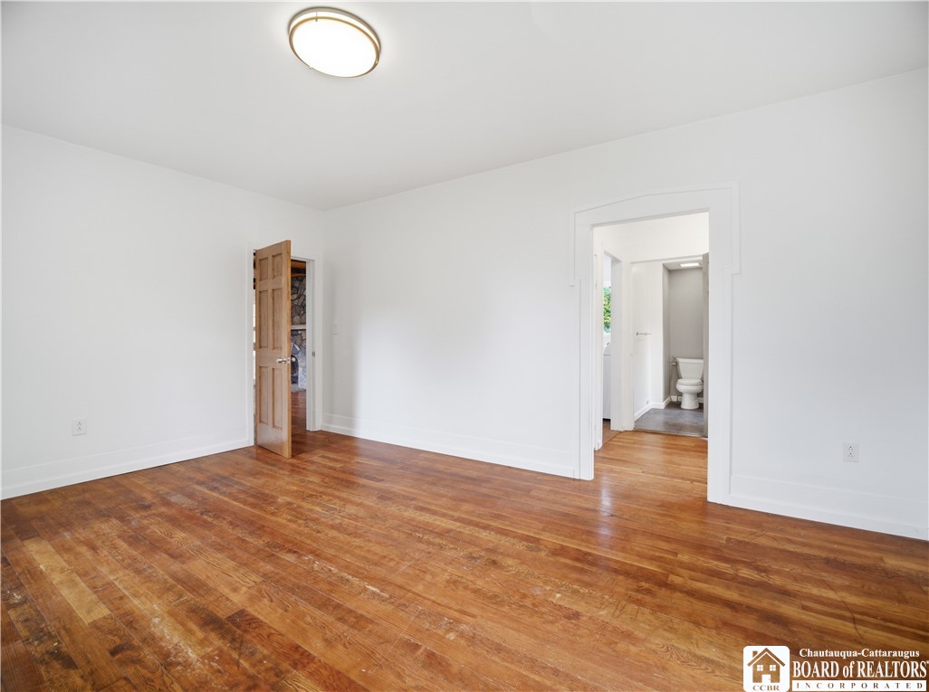 9741 East Lake Road Ripley, NY 14775 - Photo 18 of 45 The primary bedroom situated on the first floor is freshly painted and features original hardwood floors.