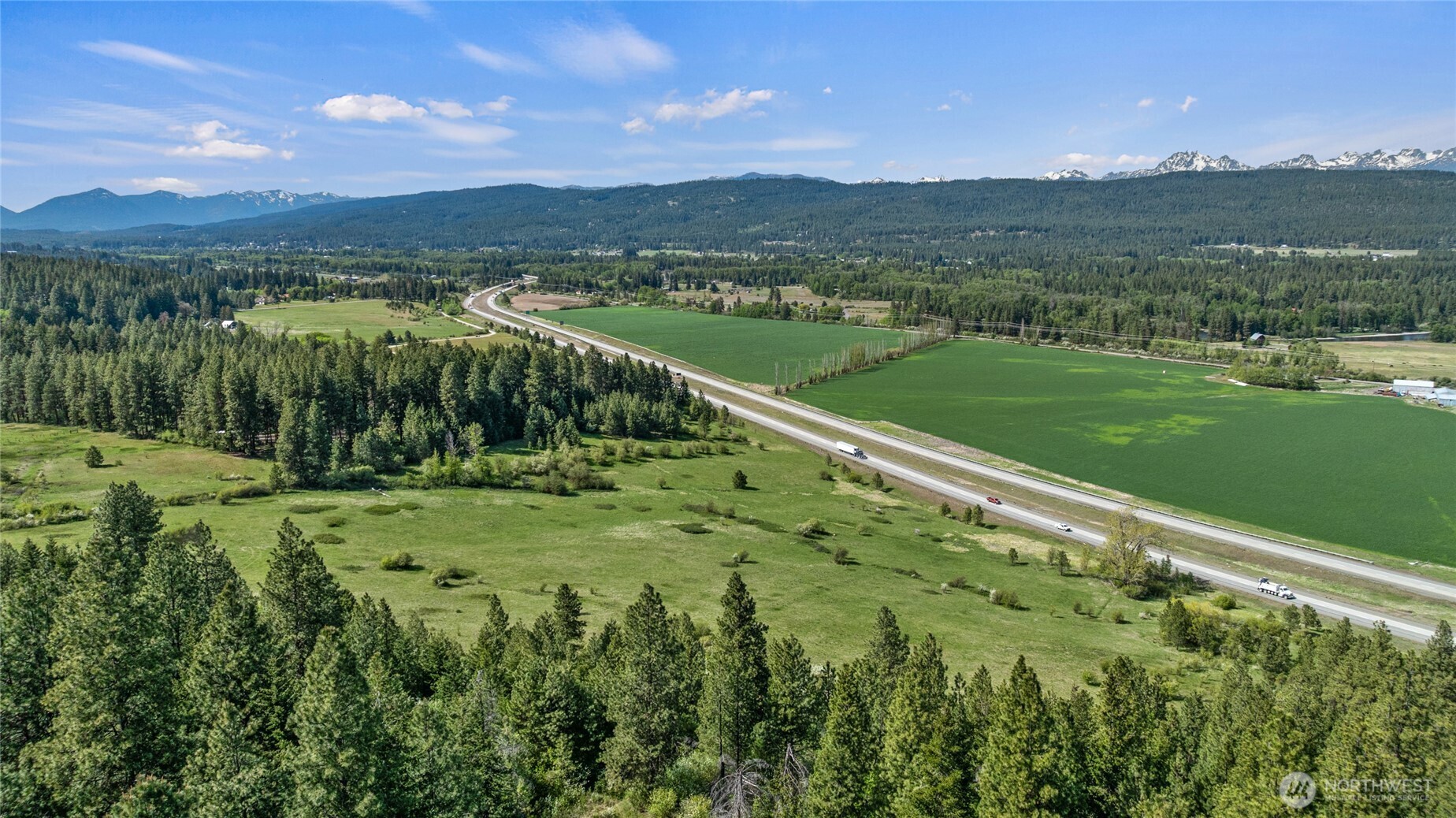 66-x1 Upper Peoh Point Road Cle Elum, WA 98922 - Photo 16 of 32 a view of a green field with mountains in the background