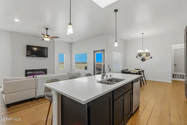 a kitchen with a sink a counter top space appliances and cabinets