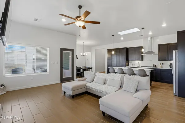 a living room with furniture and kitchen view