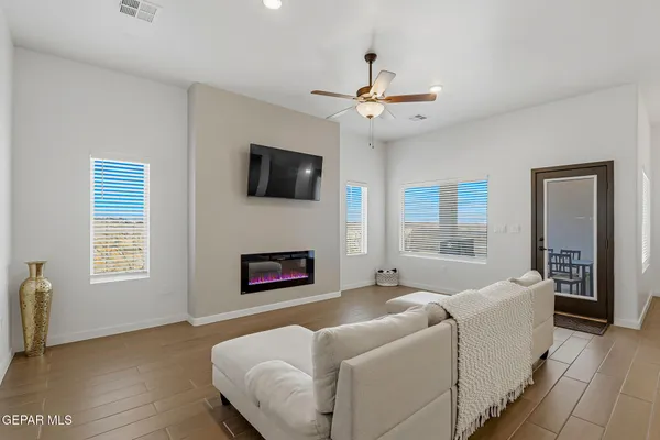 a living room with furniture fireplace and a flat screen tv