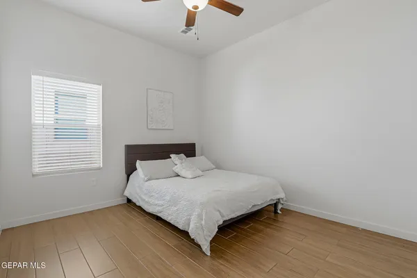 a bedroom with a bed and window