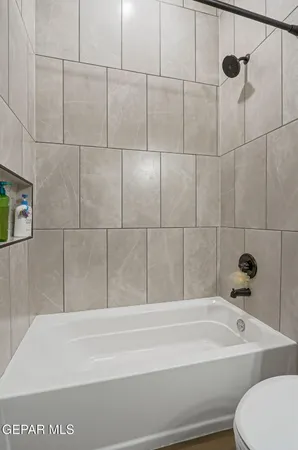 a bathroom with a bathtub and toilet