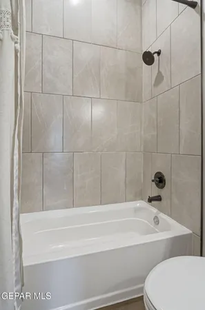 a bathroom with a bathtub and shower