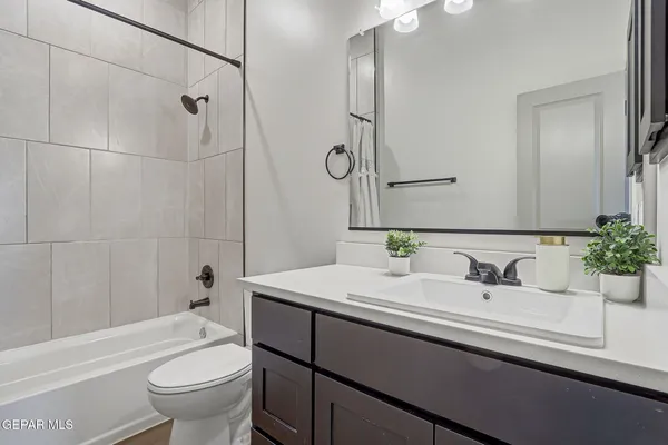 a bathroom with a sink toilet tub and shower