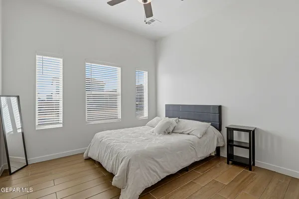 a bedroom with a bed table and a window