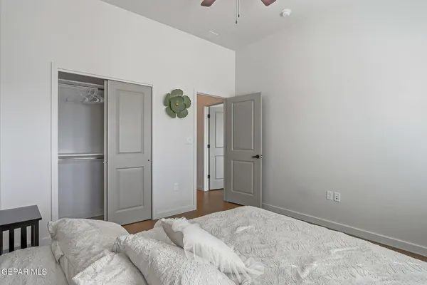 a bedroom with a bed and a refrigerator