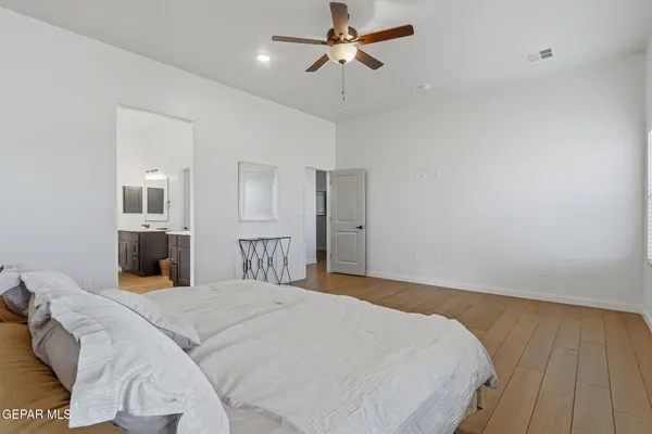 a bedroom with a large bed and dresser