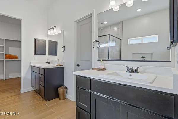 a bathroom with a sink double vanity and a mirror