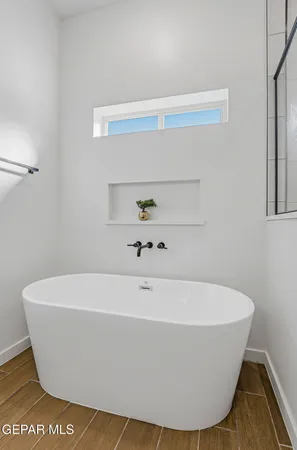 a white tub sitting next to a white sink