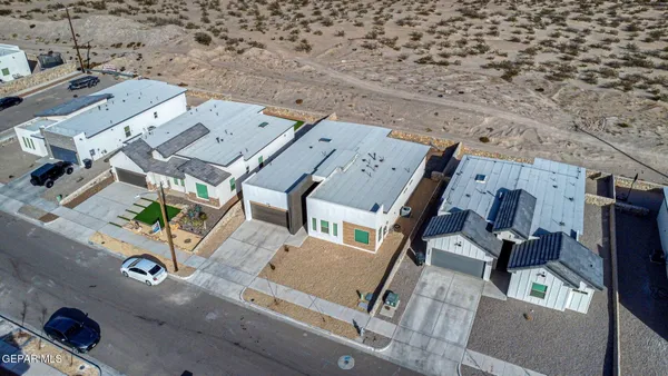 an aerial view of a backyard with seating space