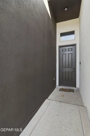 a view of an empty room with closet and a window