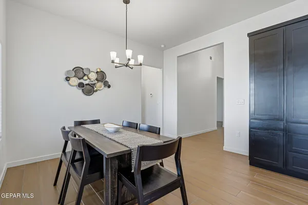 a view of a dining room with furniture wooden floor and a chandelier