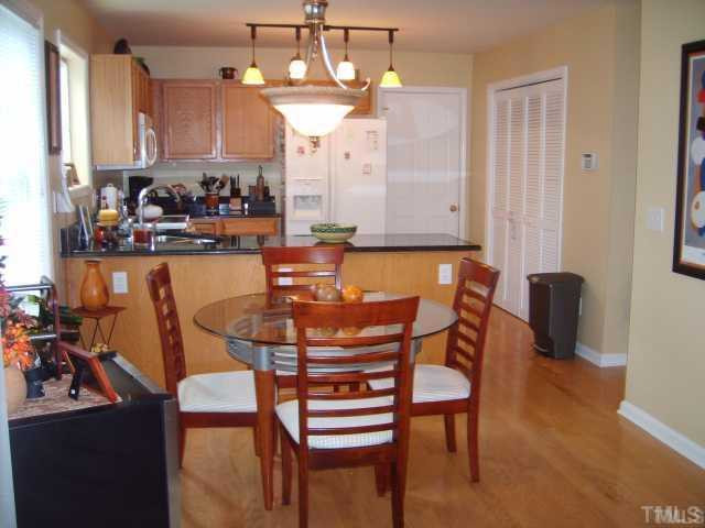 The sunny kitchen and breakfast area includes upgraded light fixtures, beautiful grant countertops, lovely hardwood floors, and a large walk-in pantry Kitchen