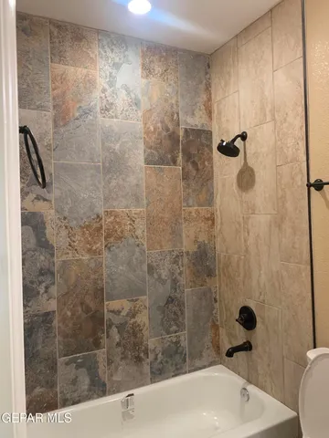 a bathroom with a shower and a sink