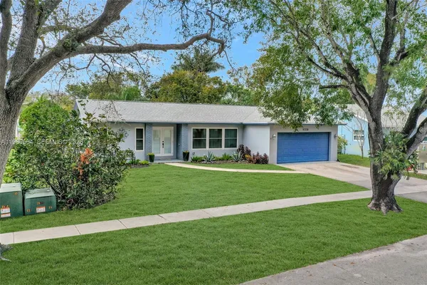 a front view of a house with a garden