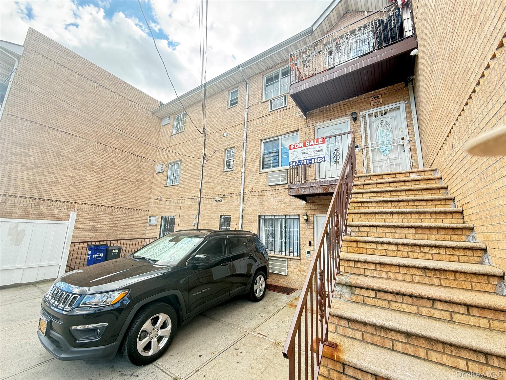 97-56 101st Street Queens, NY 11416 - Photo 11 of 17 a car parked in front of a house