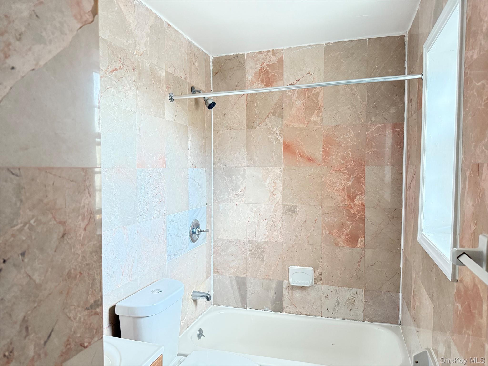 97-56 101st Street Queens, NY 11416 - Photo 17 of 17 a bathroom with a bathtub and a shower