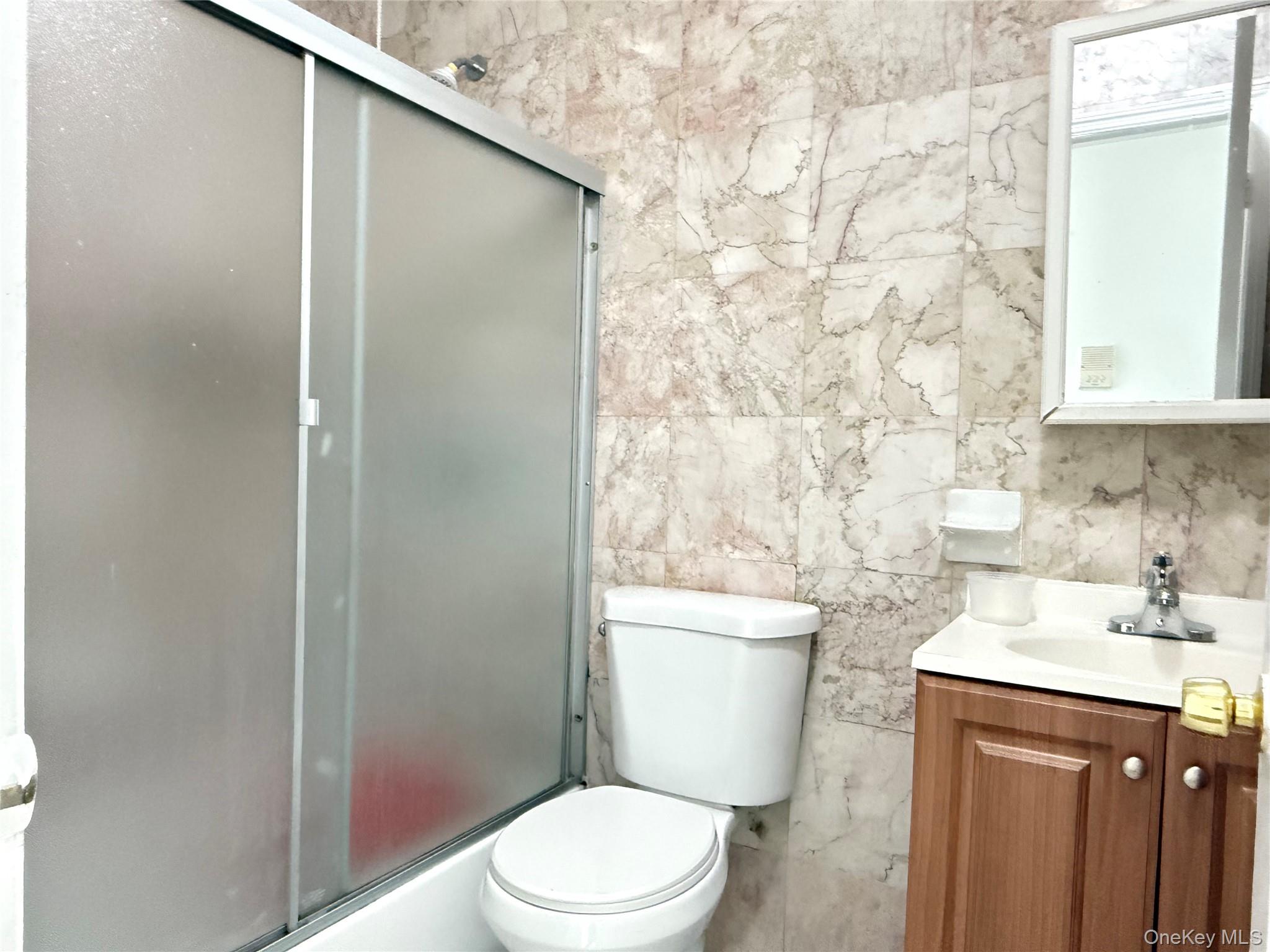 97-56 101st Street Queens, NY 11416 - Photo 9 of 17 a bathroom with a toilet a sink and a shower