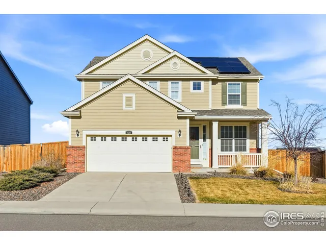 a view of a white house with large windows
