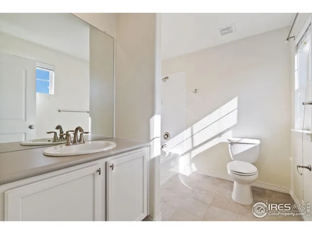 a bathroom with a sink a toilet a mirror and vanity