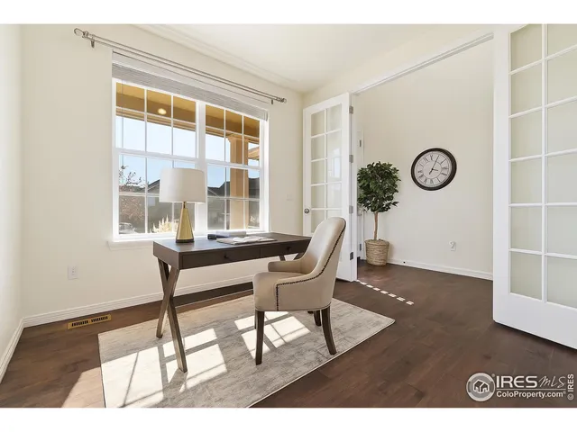 a view of a room with furniture and wooden floor
