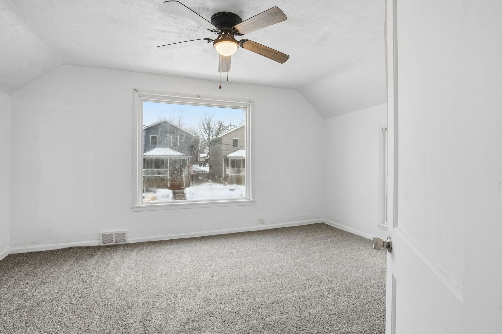 1306 17th Street Moline, IL 61265 - Photo 11 of 14 an empty room with a ceiling fan and a window
