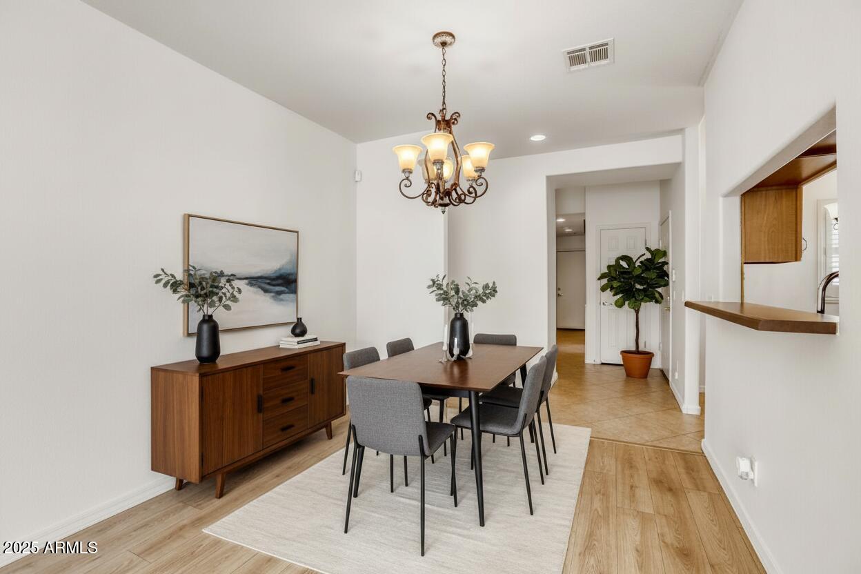 7101 West Beardsley Road, Unit 1403 Glendale, AZ 85308 - Photo 11 of 40 a view of a dining room with furniture and wooden floor