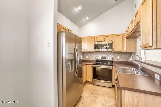 an empty room with a ceiling fan and carpet